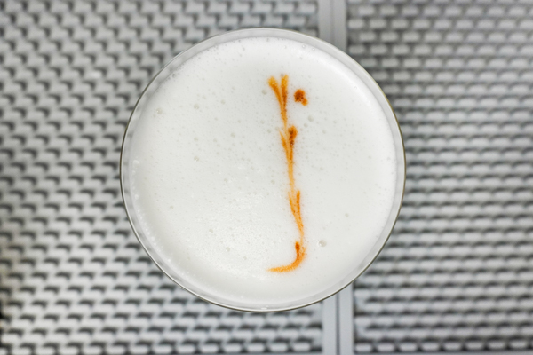 Cocktail bitters on top of egg white foam
