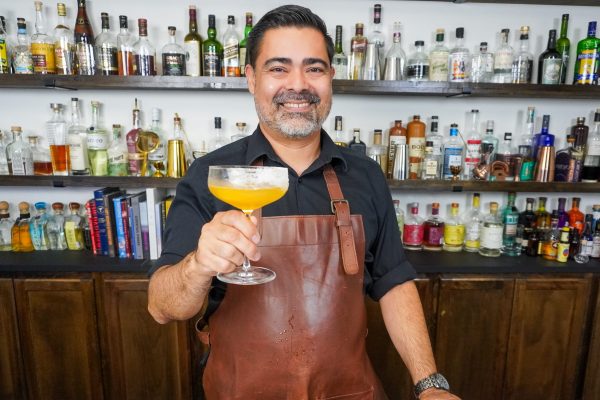 popular bartender holding a sidecar cocktail