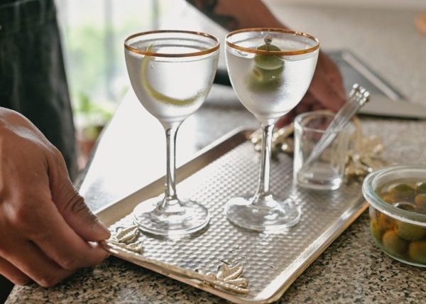 1 Martini and 1 Vesper crafted cocktails on a serving tray in cocktail glasses with picks and garnishes by M Cooper unsplash