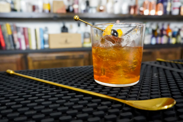 bar spoon to mix buffalo trace old fashioned spirit-forward whiskey cocktail with bold flavor notes and a citrus peel