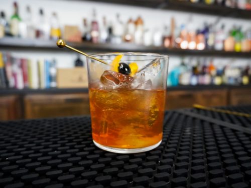 https://149347875.v2.pressablecdn.com/wp-content/uploads/2019/01/cozy-cocktail-with-bitters-and-simple-syrup-with-maraschino-cherry-500x375.jpg