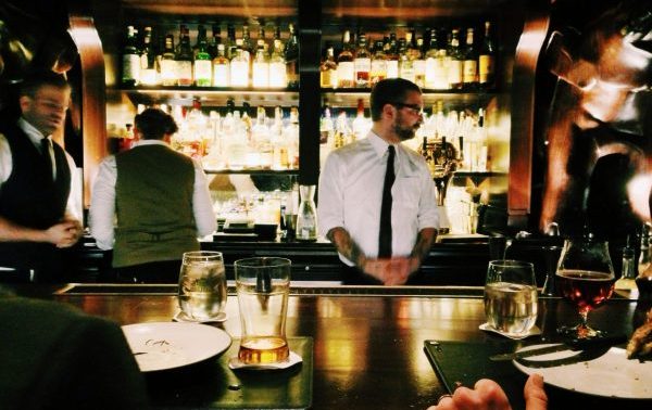 waiter standing in front of a restaurant bar