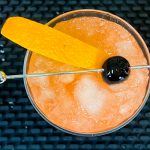 7. Refreshing cocktail hour drink with a juicy orange slice