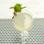 pale yellow-green Southside cocktail with mint garnish