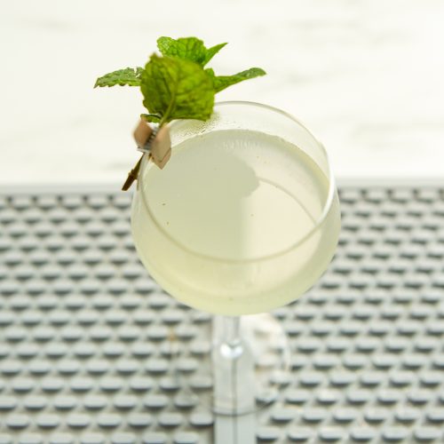 pale yellow-green Southside cocktail with mint garnish