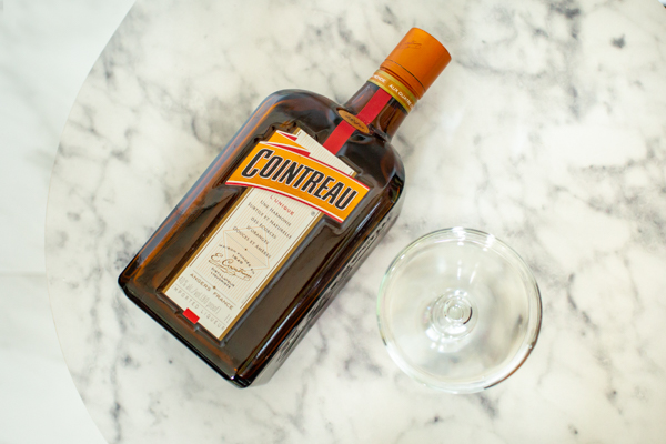 Bottle of Cointreau for the perfect cocktail with a cocktail cup