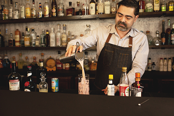 head bartender making a cocktail with luxardo maraschino liqueur and Cointreau