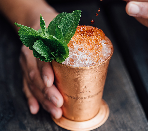 12. bitters being dropped in a perfect cocktail over crushed ice by adam Jaime via unsplash