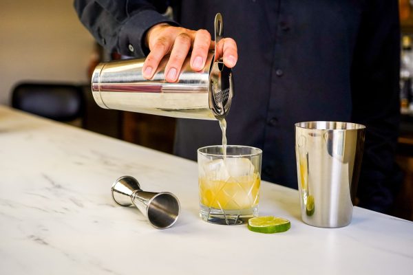 7. perfect cocktail being poured from a craft cocktail kit, the perfect bartender gift