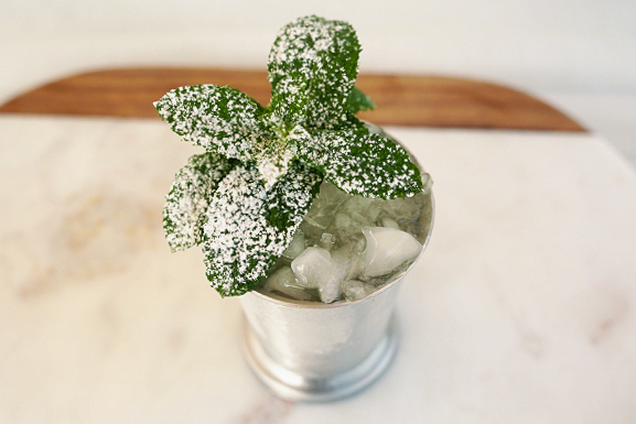 1. Julep with muddled mint and creative cocktail garnishes of sprigs of mint with powdered sugar in a julep cup