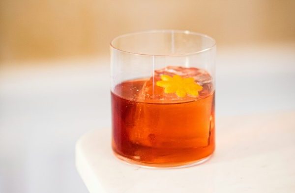 Old Fashioned glass of Campari with an orange peel garnish