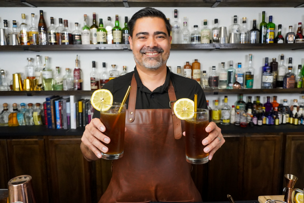 Bartender holding an excellent drink perfect for a hot day