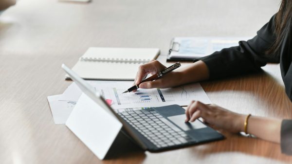 a hand creating a real PAR sheet on a laptop computer with Google sheets