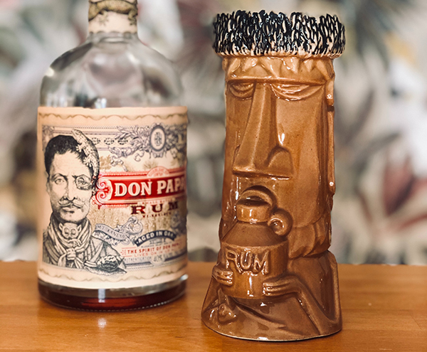 drink made with an array of fruit juices and citrus spice syrup in a tiki mug by Britta Preusse unsplash