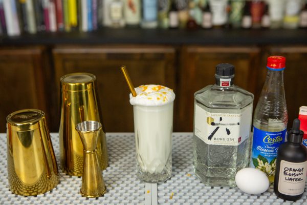 Ramos Gin Fizz with a bottle of gin, whole egg, and other ingredients
